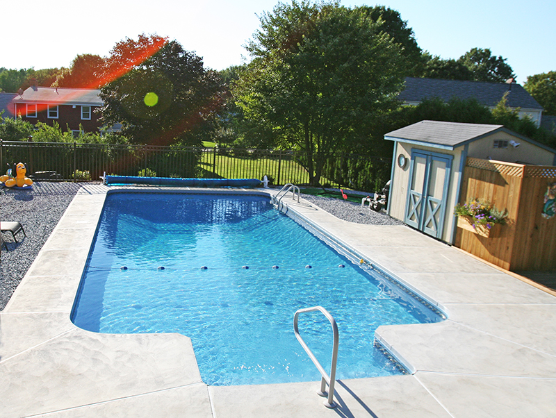 Integrated backyard poolscape with decking, circulation, and coordinated perimeter work